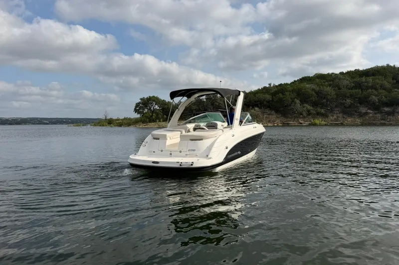 Slide: The Image of 2008 Chaparral 256 SSi boat on a calm lake with scenic background. - 21
