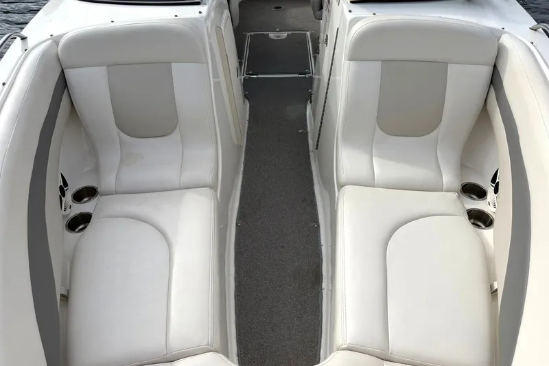Slide: The Image of Interior seating of 2008 Chaparral 256 SSi boat, featuring white cushioned seats. - 47
