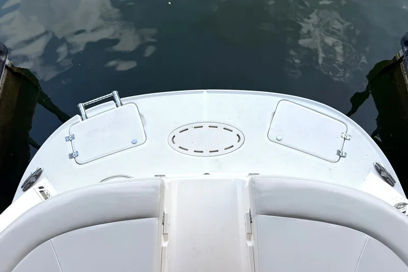 Slide: The Image of 2008 Chaparral 256 SSi boat deck, featuring storage compartments and water reflection. - 26