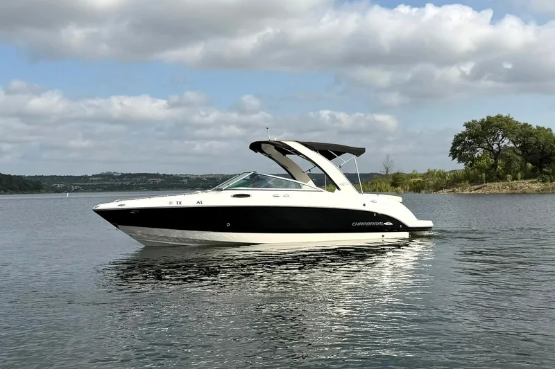 Slide: The Image of 2008 Chaparral 256 SSi boat on a calm lake under a cloudy sky. - 8