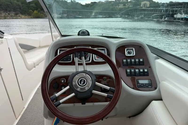 Slide: The Image of Steering console of a 2008 Chaparral 256 SSi boat with lake view. - 52