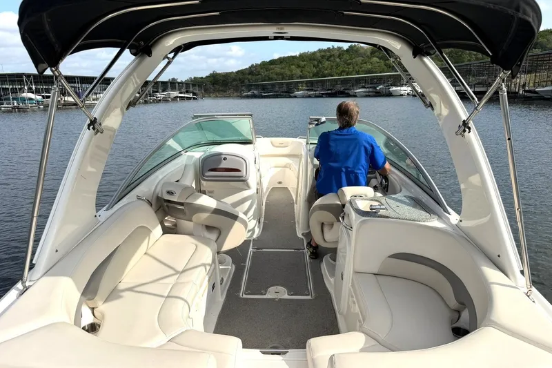 Slide: The Image of 2008 Chaparral 256 SSi boat interior with driver on a calm lake. - 3