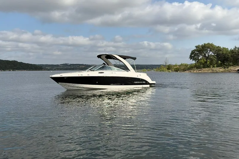 Slide: The Image of 2008 Chaparral 256 SSi boat on a calm lake under a cloudy sky. - 10