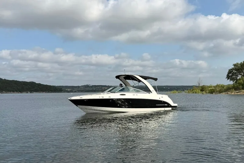 Slide: The Image of 2008 Chaparral 256 SSi boat on a calm lake under a cloudy sky. - 11