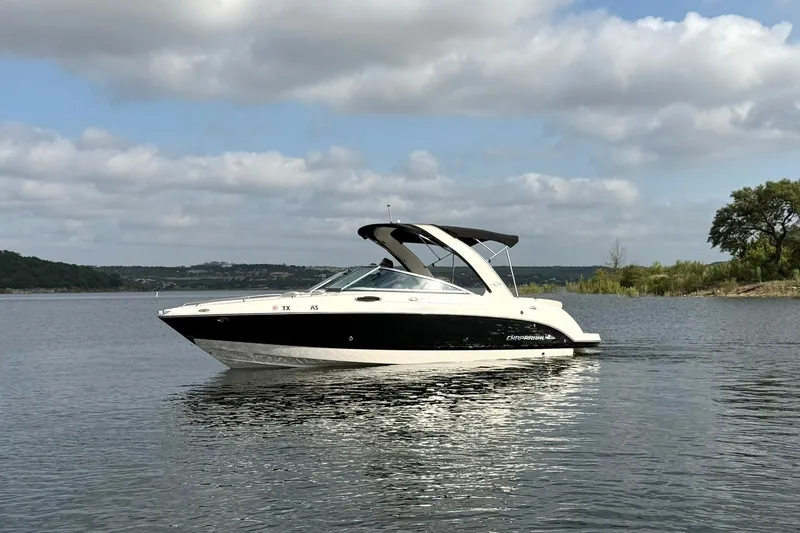Slide: The Image of 2008 Chaparral 256 SSi boat on a calm lake under cloudy skies. - 9