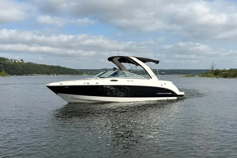 Slide: The Image of 2008 Chaparral 256 SSi boat on a calm lake under a cloudy sky. - 12