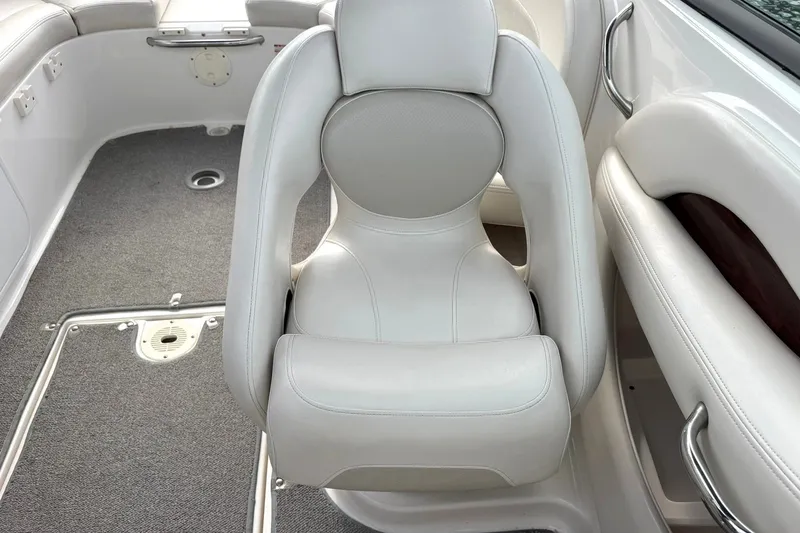 Slide: The Image of 2008 Chaparral 256 SSi boat interior with white leather seating and carpeted flooring. - 37