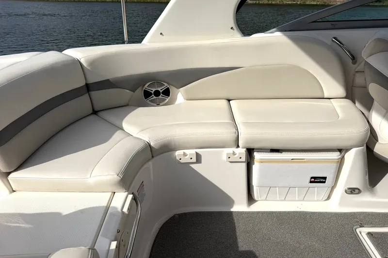 Slide: The Image of 2008 Chaparral 256 SSi boat interior with beige seating and built-in cooler. - 33