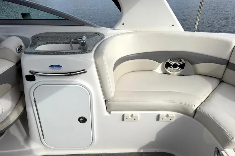 Slide: The Image of 2008 Chaparral 256 SSi boat interior with sink and cushioned seating. - 40
