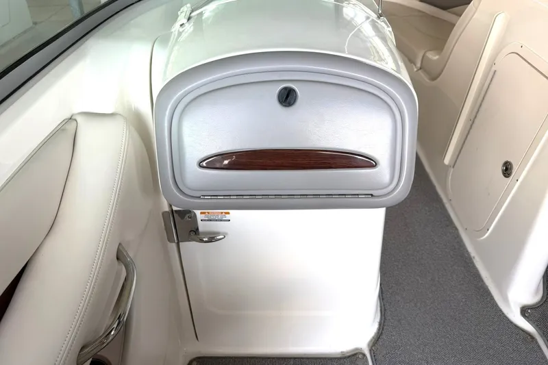 Slide: The Image of 2008 Chaparral 256 SSi boat interior with white seating and storage compartment. - 38