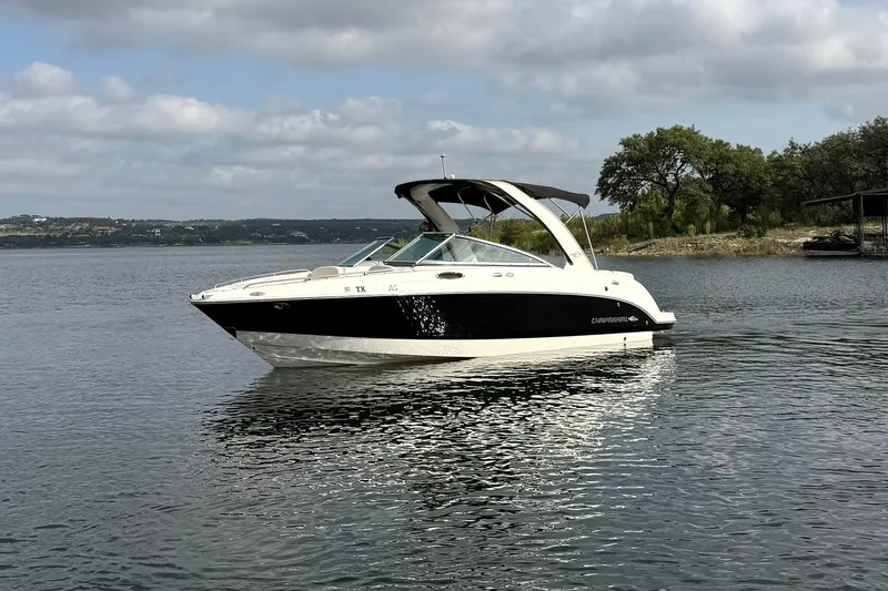 Slide: The Image of 2008 Chaparral 256 SSi boat on a calm lake under cloudy skies. - 13