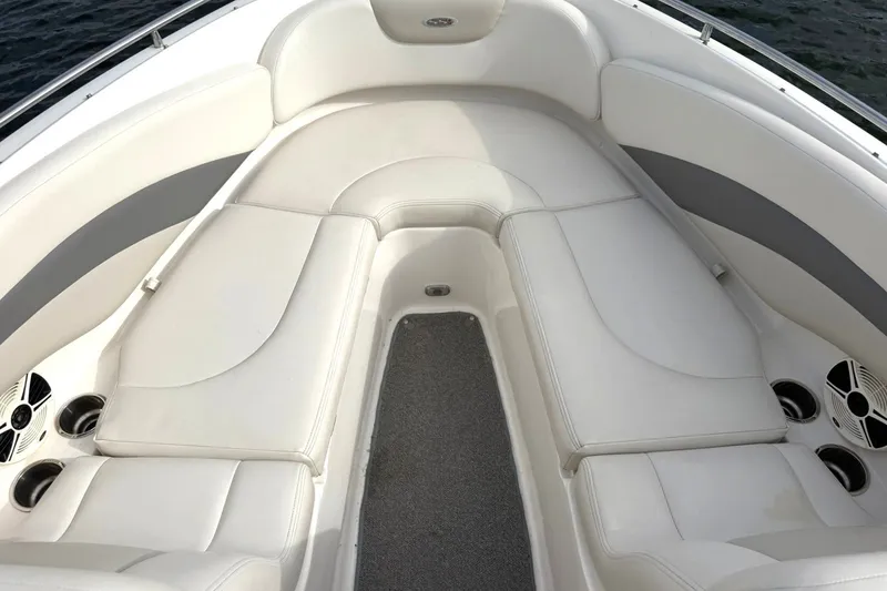 Slide: The Image of 2008 Chaparral 256 SSi boat interior with white cushioned seating and cup holders. - 43