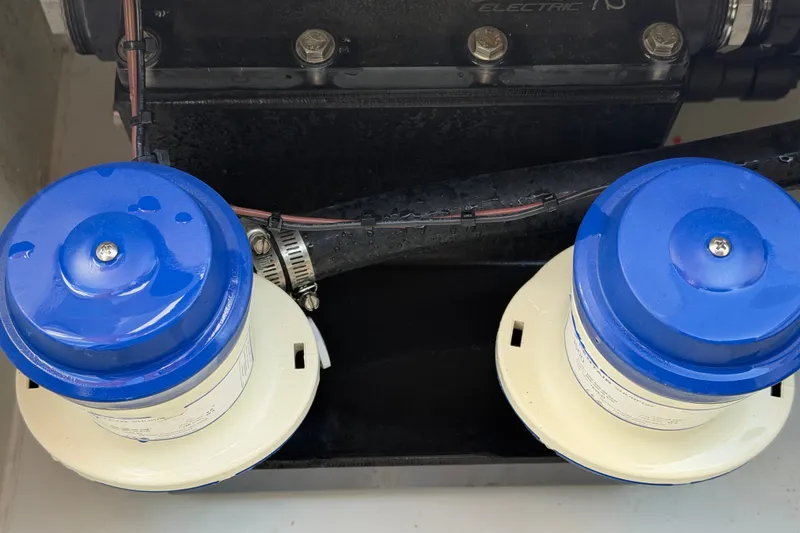 Slide: The Image of Engine components of a 2024 Costa Custom Boats 264HC with blue and white filters. - 25