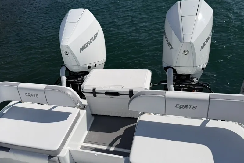 Slide: The Image of 2024 Costa Custom Boats 264HC with dual Mercury engines on water. - 19