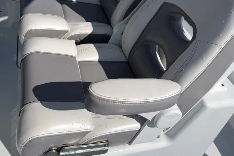 Slide: The Image of 2024 Costa Custom Boats 264HC seat with gray and white cushioned design. - 18