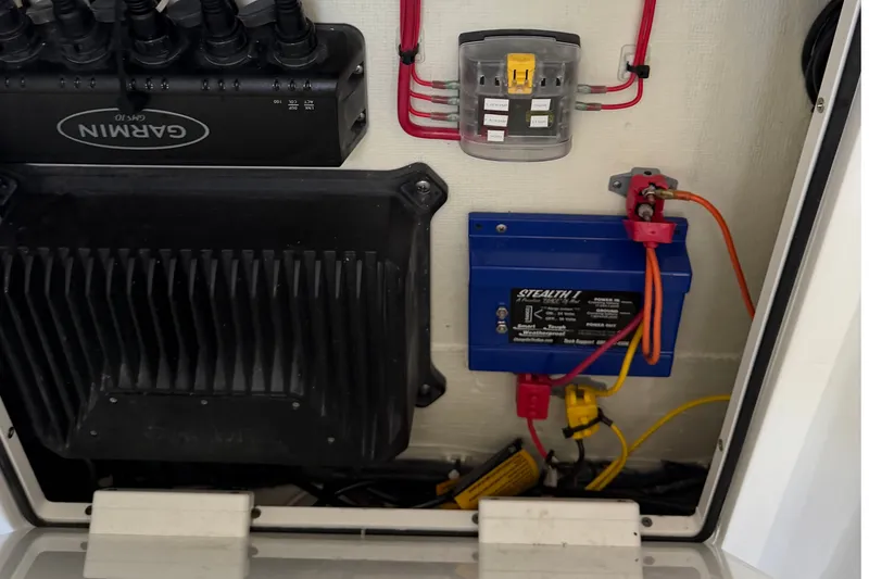 Slide: The Image of Electrical components inside a 2024 Costa Custom Boats 264HC, featuring Garmin and Stealth 1 systems. - 23