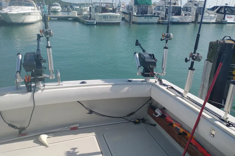 Slide: The Image of 1986 Tiara Yachts 3100 Open with fishing gear at marina dock. - 7