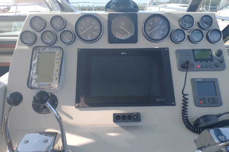 Slide: The Image of Control panel of a 1986 Tiara Yachts 3100 Open, featuring gauges and navigation equipment. - 8