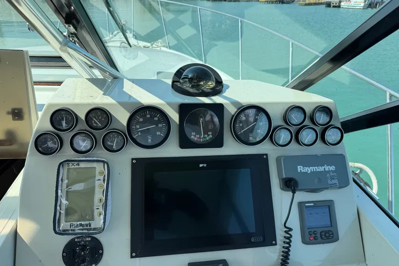 Slide: The Image of Dashboard of a 1986 Tiara Yachts 3100 Open with navigation instruments and gauges. - 9
