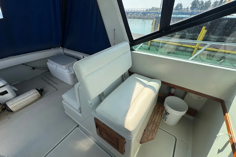Slide: The Image of 1986 Tiara Yachts 3100 Open interior with seating and marine equipment. - 3