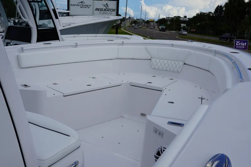 Slide: The Image of 2027 Sportsman Heritage 261 Center Console boat interior with white seating and storage compartments. - 18
