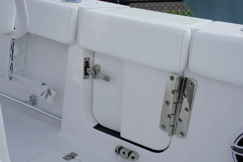 Slide: The Image of 2027 Sportsman Heritage 261 Center Console boat interior, featuring white seating and stainless steel hardware. - 13