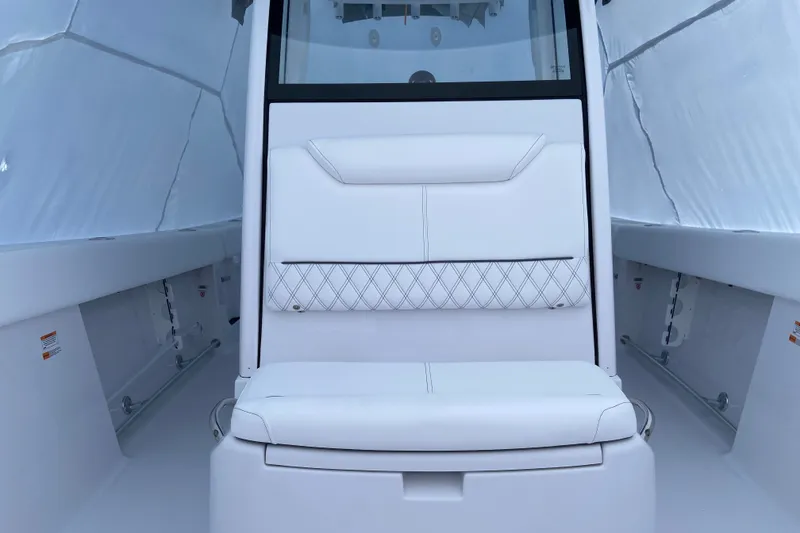 Slide: The Image of 2027 Sportsman Heritage 261 Center Console boat interior with white cushioned seating. - 8