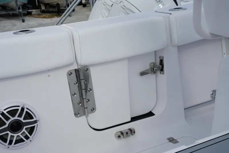 Slide: The Image of 2027 Sportsman Heritage 261 Center Console boat interior with speaker and storage compartment. - 11