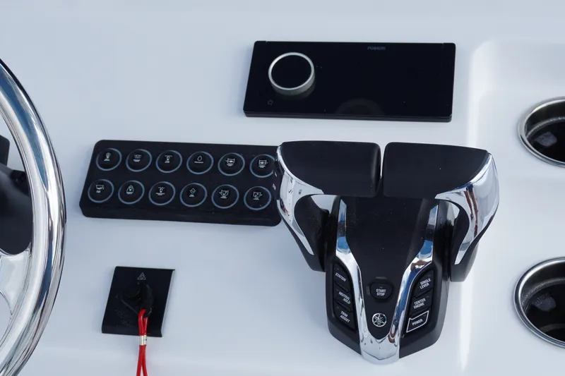 Slide: The Image of Control panel of 2027 Sportsman Heritage 261 Center Console boat with modern throttle and buttons. - 17