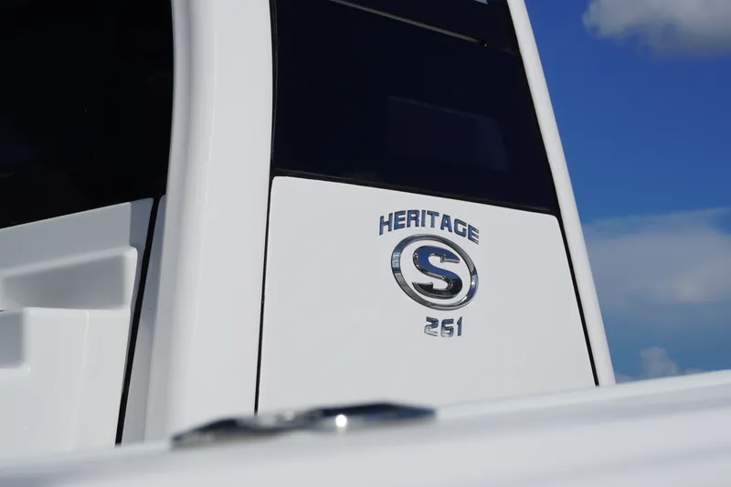 Slide: The Image of 2027 Sportsman Heritage 261 Center Console boat emblem against blue sky. - 2