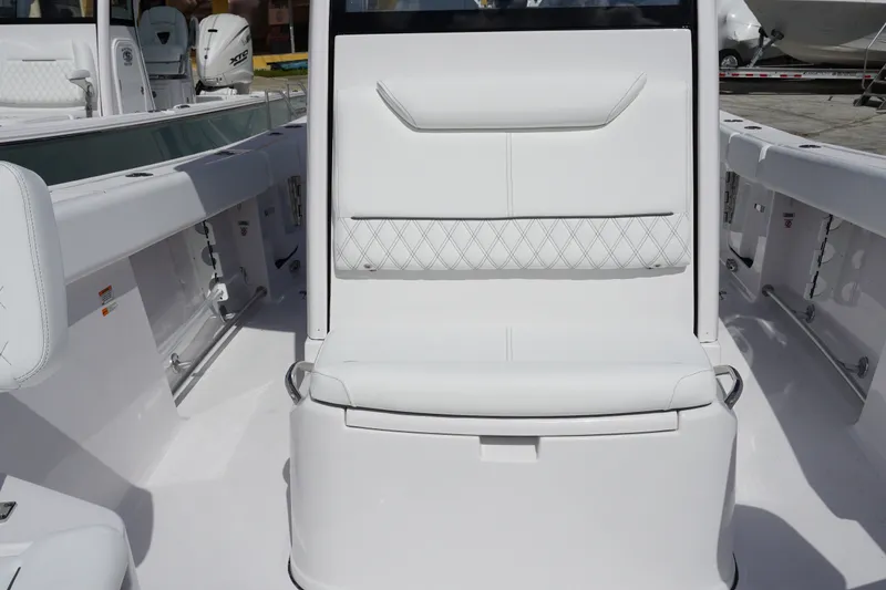 Slide: The Image of 2027 Sportsman Heritage 261 Center Console boat interior with white seating and sleek design. - 24