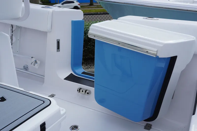 Slide: The Image of 2027 Sportsman Heritage 261 Center Console boat interior with blue storage compartment. - 14