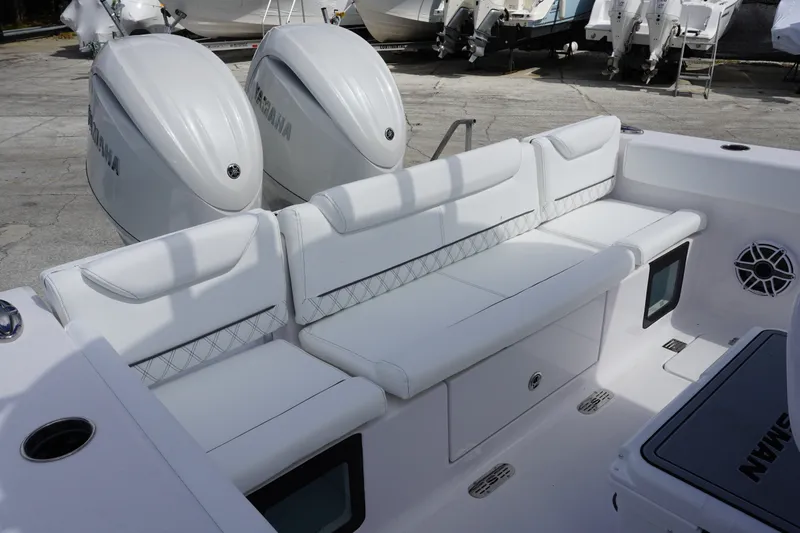 Slide: The Image of 2027 Sportsman Heritage 261 Center Console boat with white seating and dual Yamaha engines. - 5