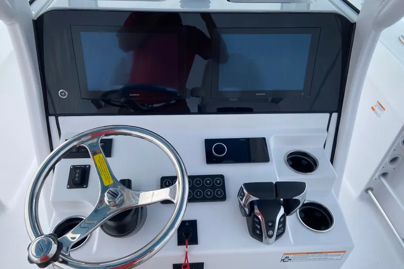 Slide: The Image of 2027 Sportsman Heritage 261 Center Console dashboard with dual screens and steering wheel. - 6