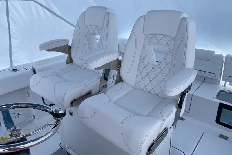 Slide: The Image of Luxurious white seating on 2027 Sportsman Heritage 261 Center Console boat. - 5