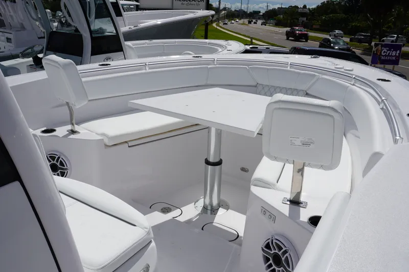 Slide: The Image of 2027 Sportsman Heritage 261 Center Console boat interior with seating and table. - 22