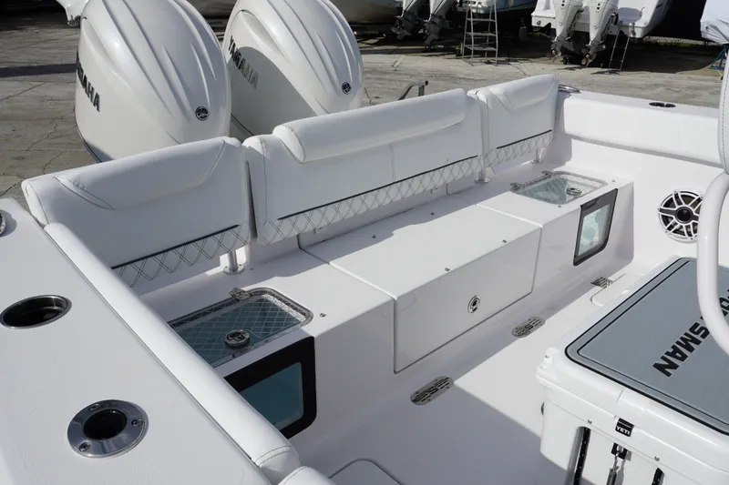 Slide: The Image of 2027 Sportsman Heritage 261 Center Console boat interior with Yamaha engines, featuring seating and storage. - 4