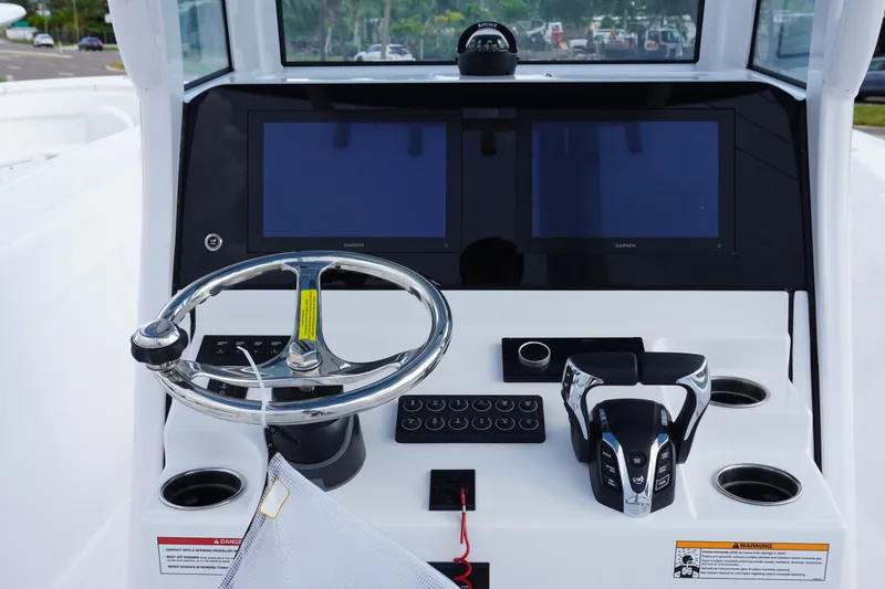 Slide: The Image of 2027 Sportsman Heritage 261 Center Console helm with dual screens and steering wheel. - 15