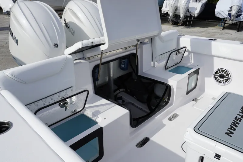 Slide: The Image of 2027 Sportsman Heritage 261 Center Console boat interior with Yamaha engines and storage compartments. - 6