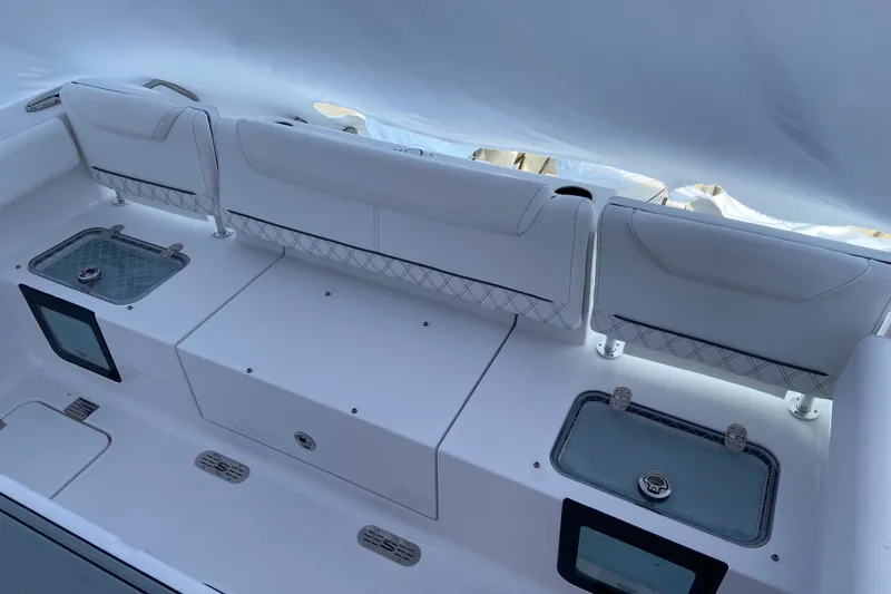 Slide: The Image of 2027 Sportsman Heritage 261 Center Console boat interior with seating and storage compartments. - 2