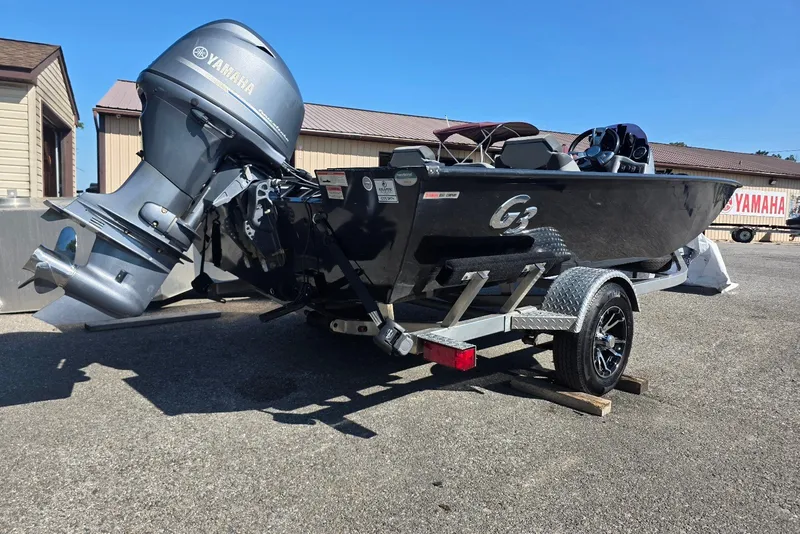 Slide: The Image of 2020 G3 Sportsman 1710 boat with Yamaha motor on trailer, parked outdoors. - 2