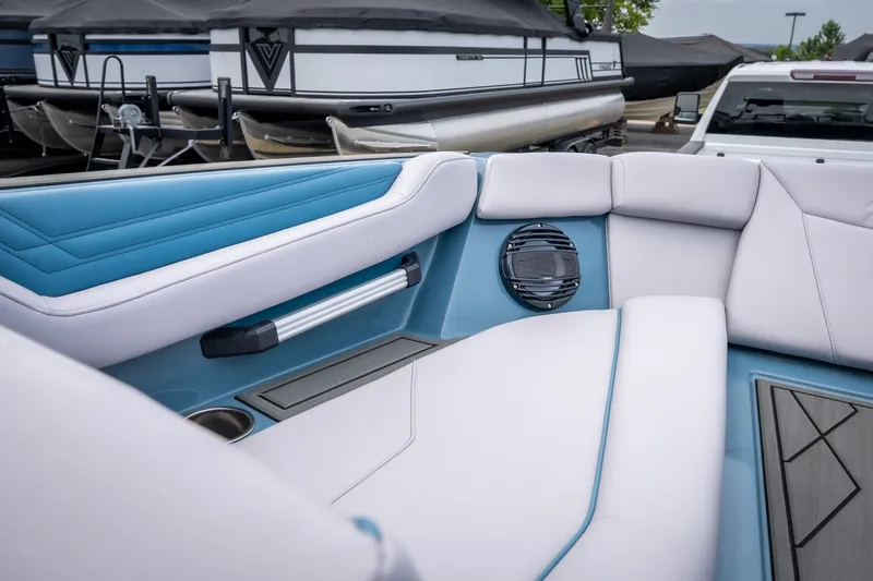 Slide: The Image of 2026 ATX Surf Boats 22 Type-S interior with blue and white seating, speaker, and cup holder. - 20