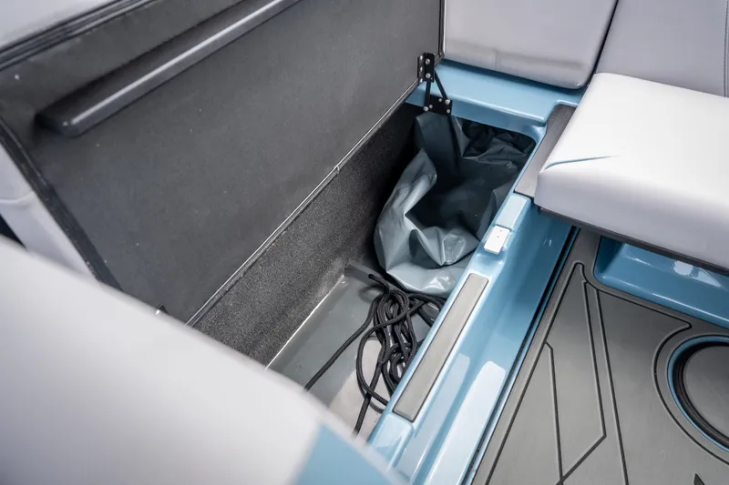 Slide: The Image of 2026 ATX Surf Boats 22 Type-S interior storage compartment with ropes and seating. - 25