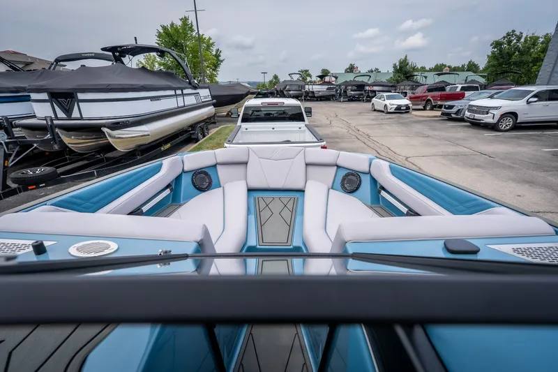 Slide: The Image of 2026 ATX Surf Boats 22 Type-S interior with blue and white seating in a parking lot. - 18