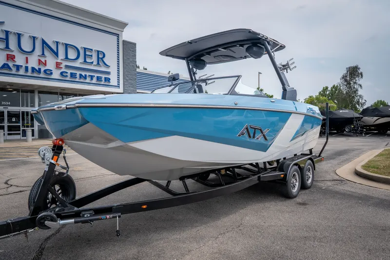 Slide: The Image of 2026 ATX Surf Boats 22 Type-S in blue, displayed at Thunder Marine Boating Center. - 2