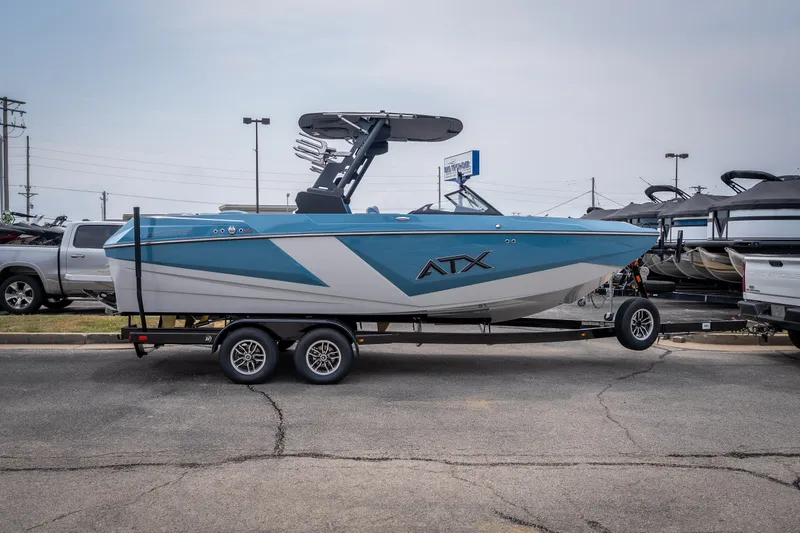 Slide: The Image of 2026 ATX Surf Boats 22 Type-S on trailer, blue and white design, parked outdoors. - 31