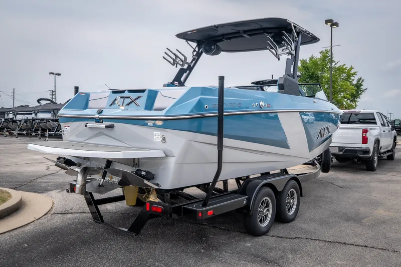 Slide: The Image of 2026 ATX Surf Boats 22 Type-S on trailer, blue and white design, parked outdoors. - 36