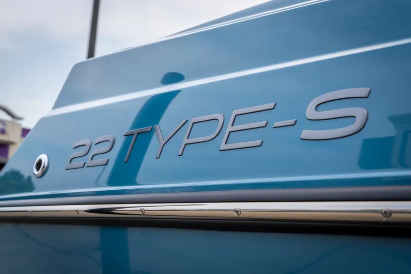 Slide: The Image of Close-up of 2026 ATX Surf Boats 22 Type-S model name on blue hull. - 35