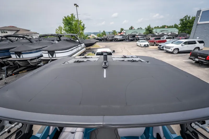 Slide: The Image of 2026 ATX Surf Boats 22 Type-S in a dealership lot, surrounded by other boats and vehicles. - 6