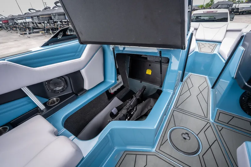Slide: The Image of Interior storage of 2026 ATX Surf Boats 22 Type-S, featuring blue and gray seating. - 23